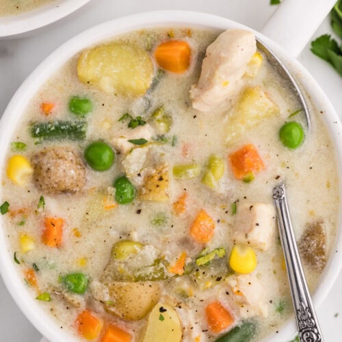 Slow Cooker Chicken Pot Pie Soup bowl served with a spoon