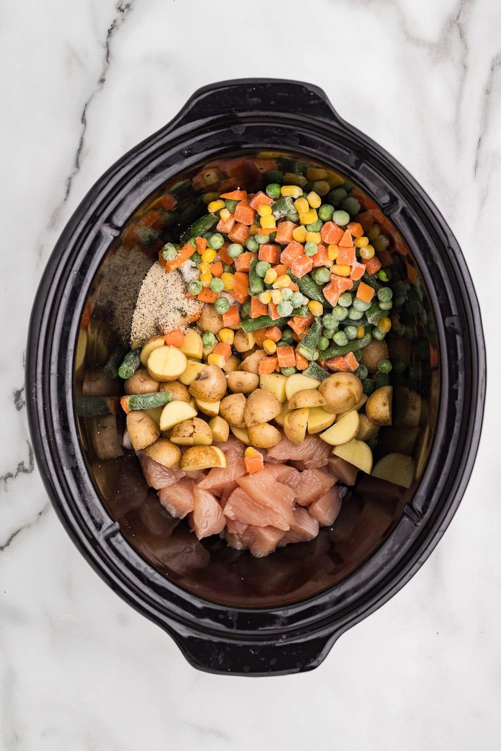 Chicken, veggies and seasoning all added to slow cooker