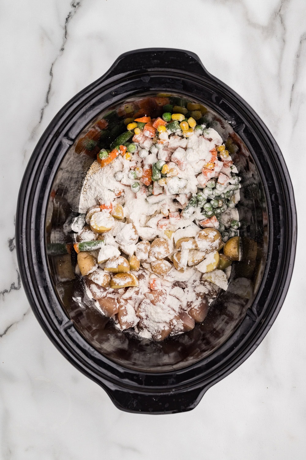 Chicken, veggies and seasoning to slow cooker Tossed with tapioca flour