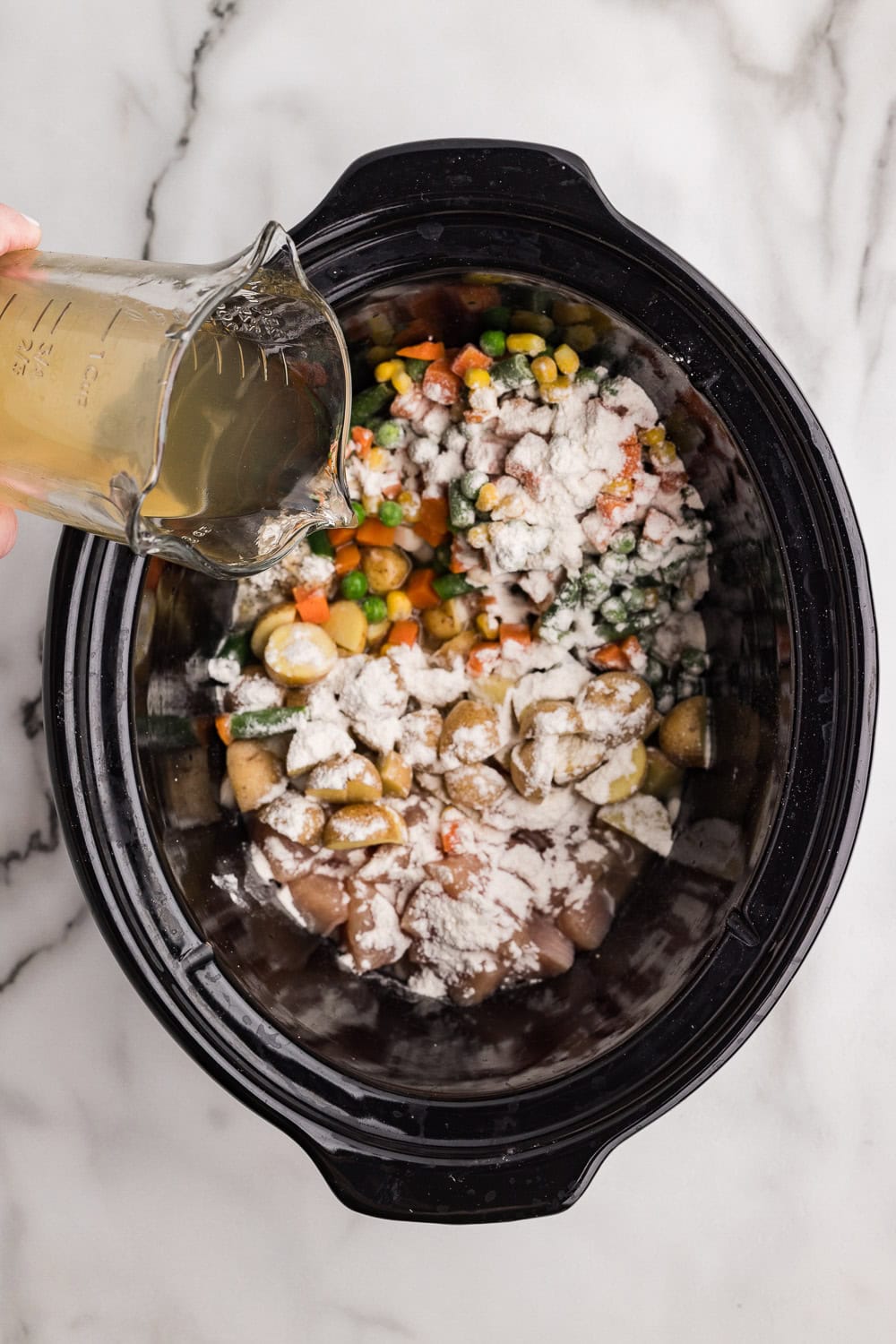 Add chicken, veggies and seasoning to slow cooker with tapioca all mixed together with chicken broth being poured on top