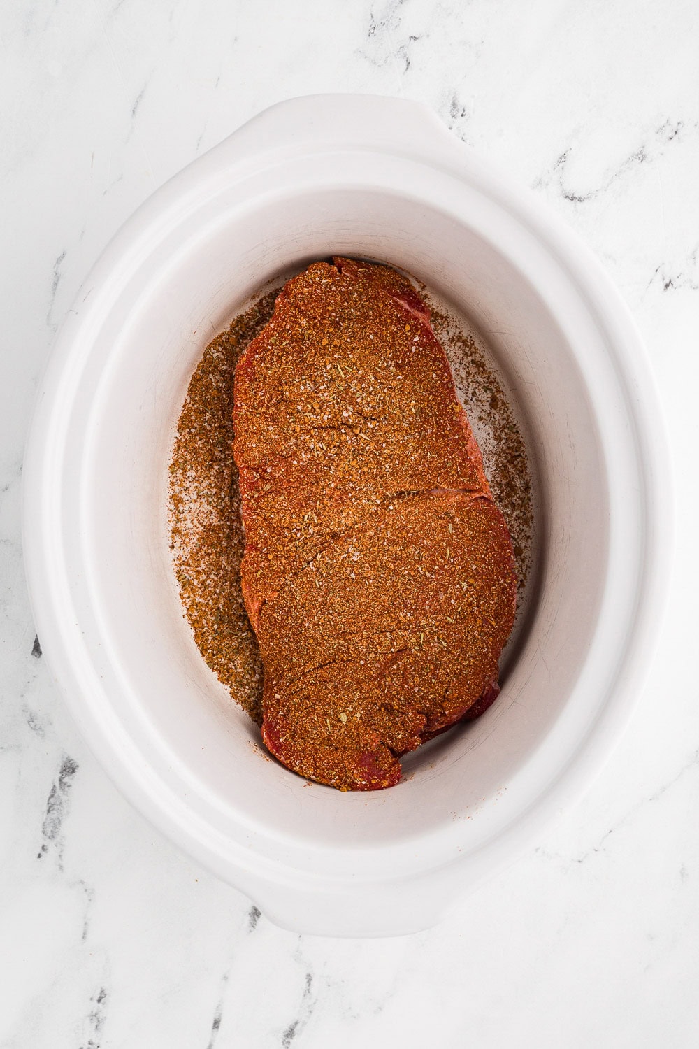 2 pound top round roast (london broil) seasoned in slow cooker