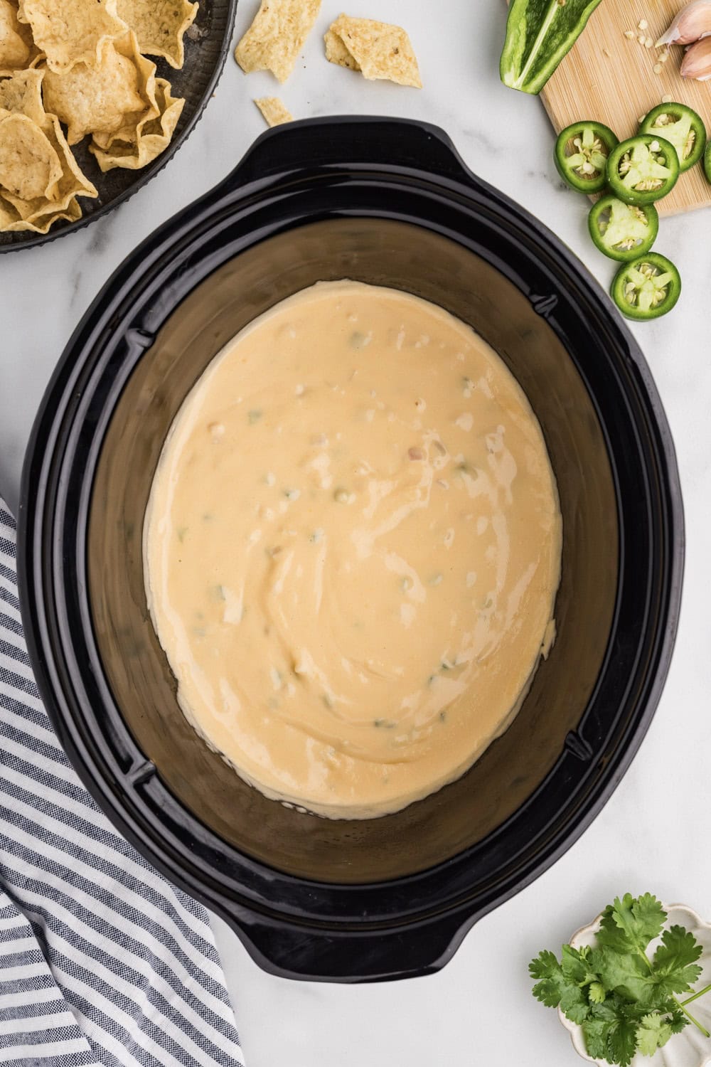 A wooden spoon in a bowl of creamy sauce