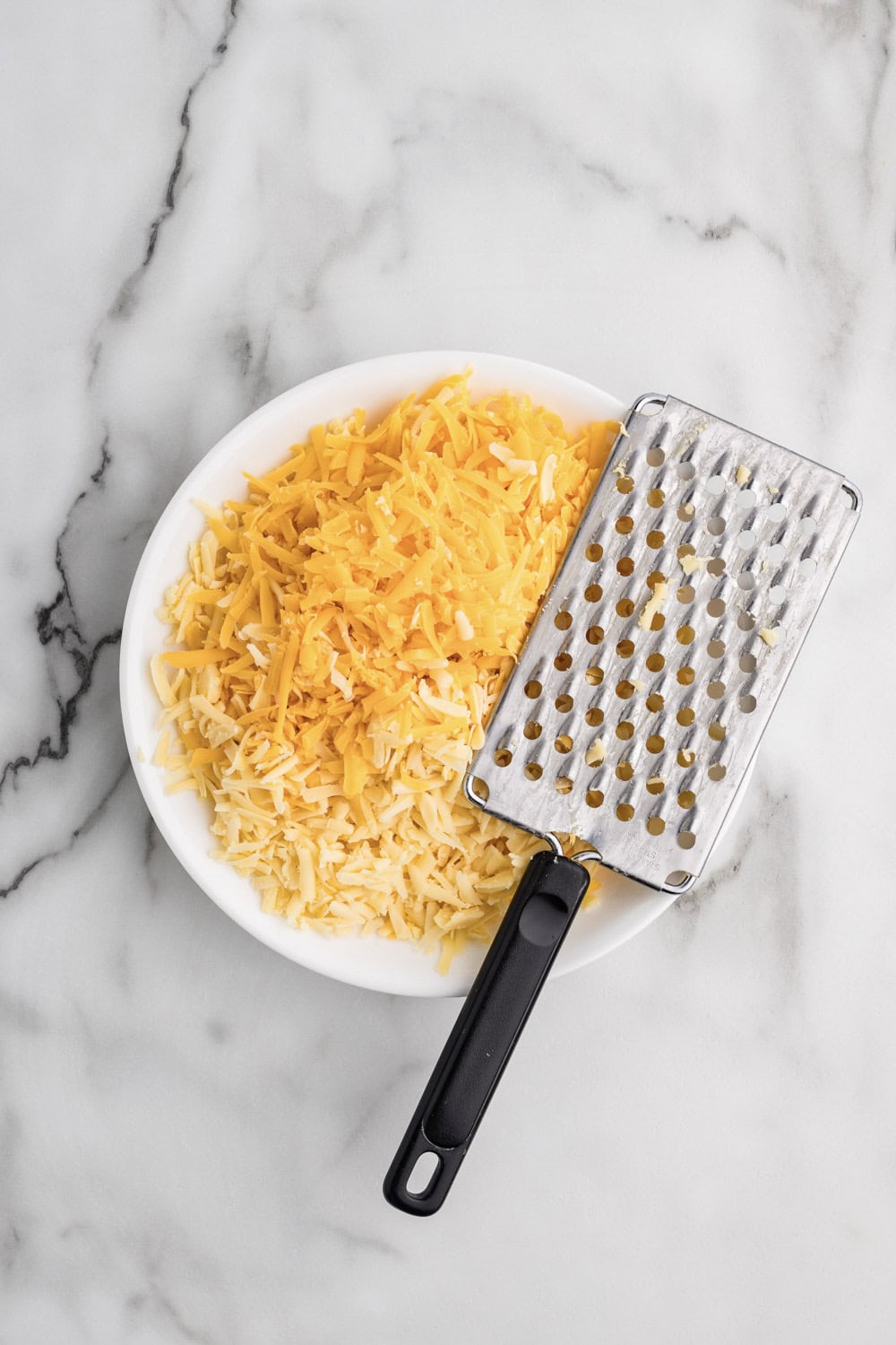shredded cheese on white plate