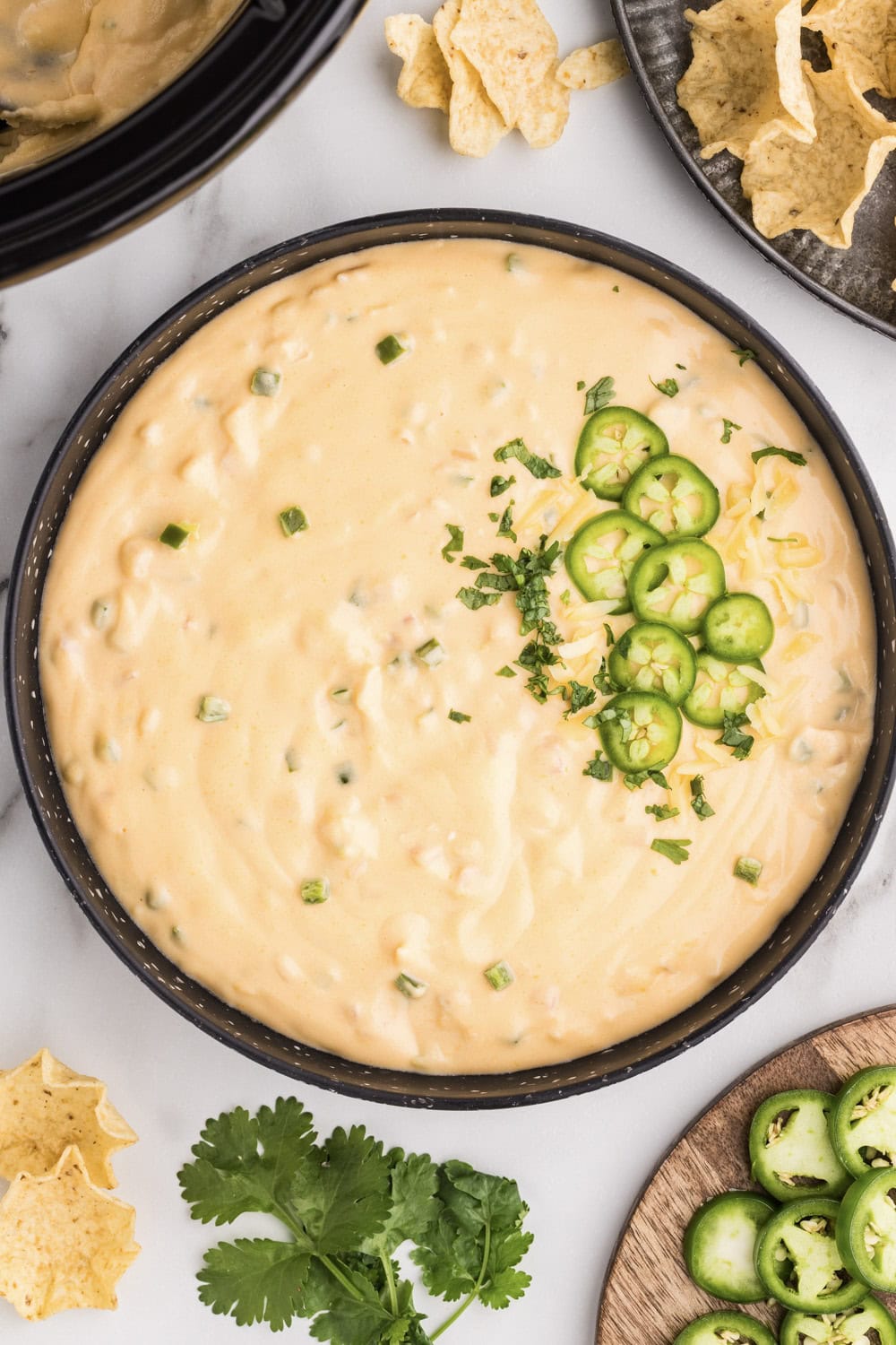 A wooden spoon in a bowl of creamy sauce