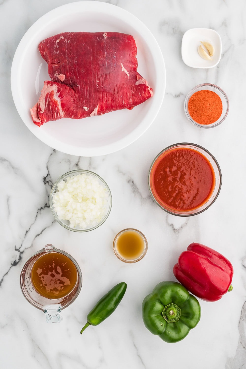 Ingredients for Easy Slow Cooker Ropa Vieja ready on counter to prepare recipe