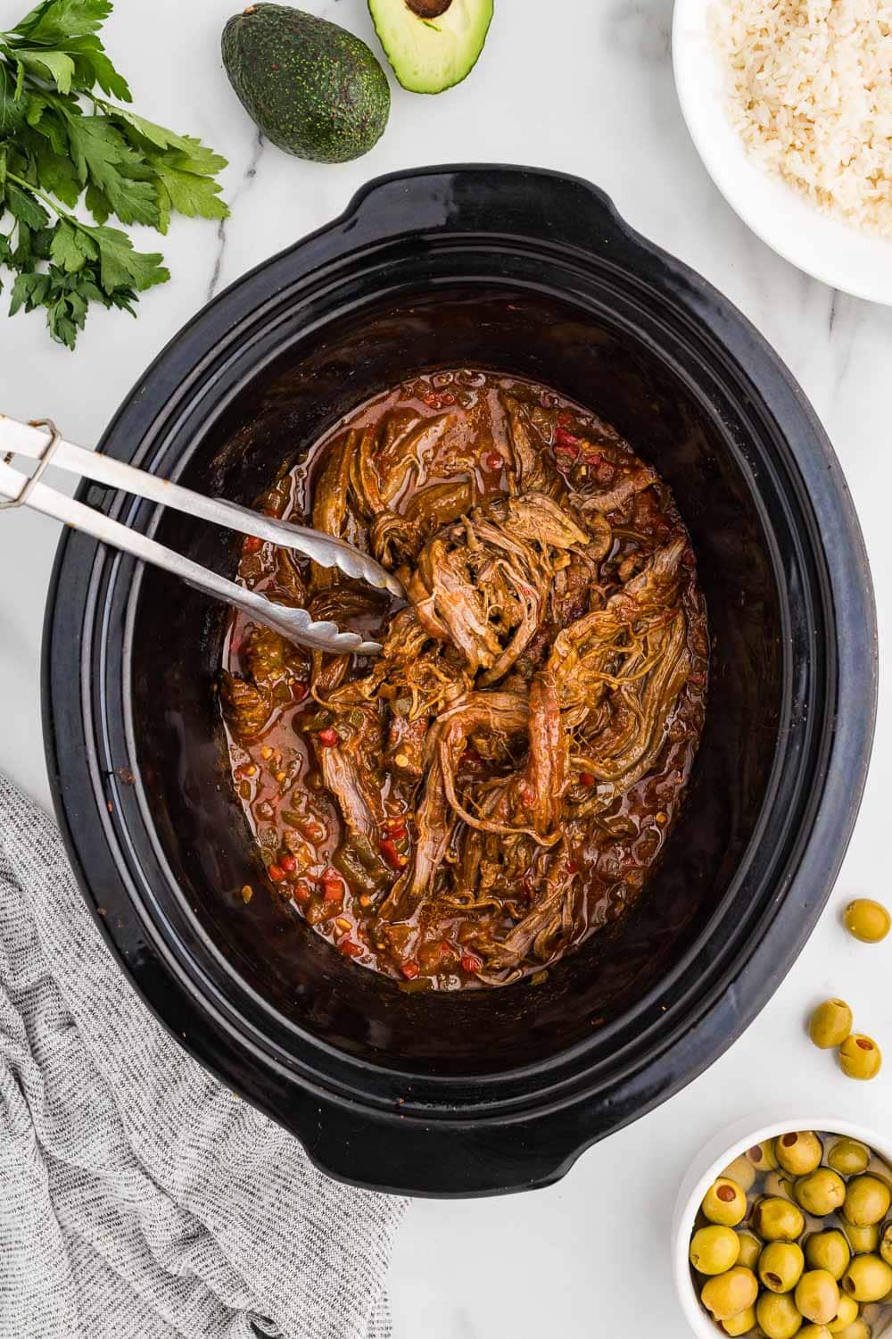 Easy Slow Cooker Ropa Vieja served with olives rice and garnished slow cooker