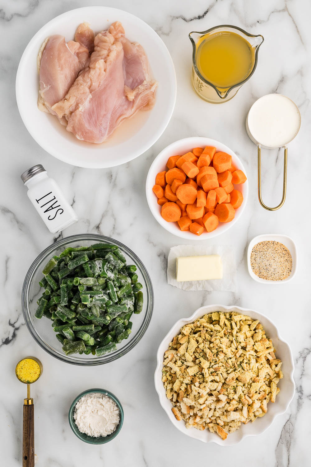Ingredients for chicken and stuffing on a marble counter