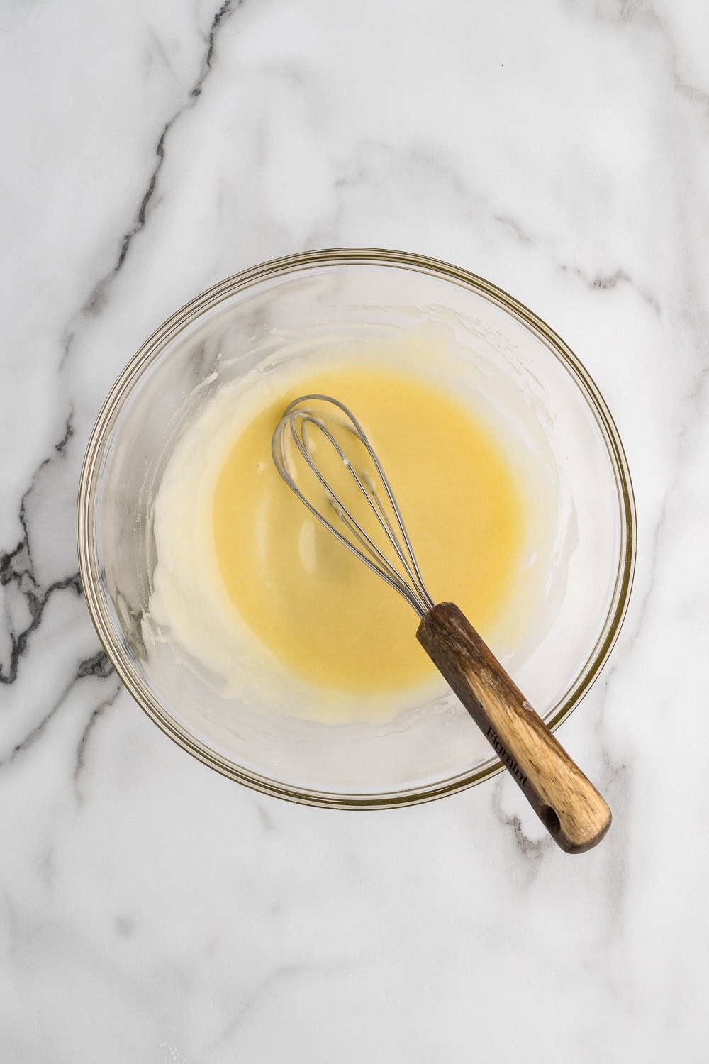 Whisking the egg yolk and sugar in a bowl