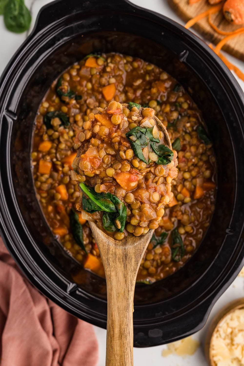 close up of wooden spoon with a scoop of lentil soup