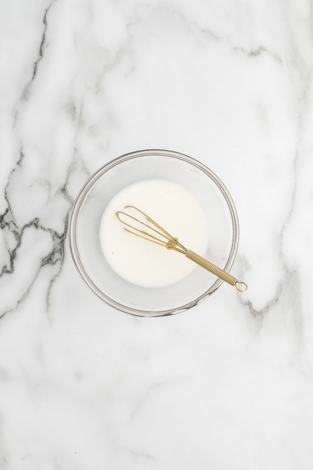 clear bowl with corn starch slurry with whisk