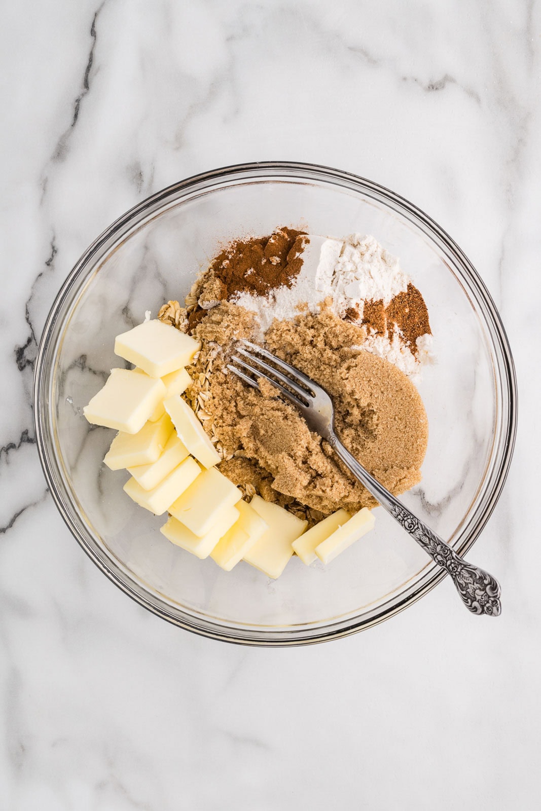 Ingredients for apple crisp topping in a glass bowl