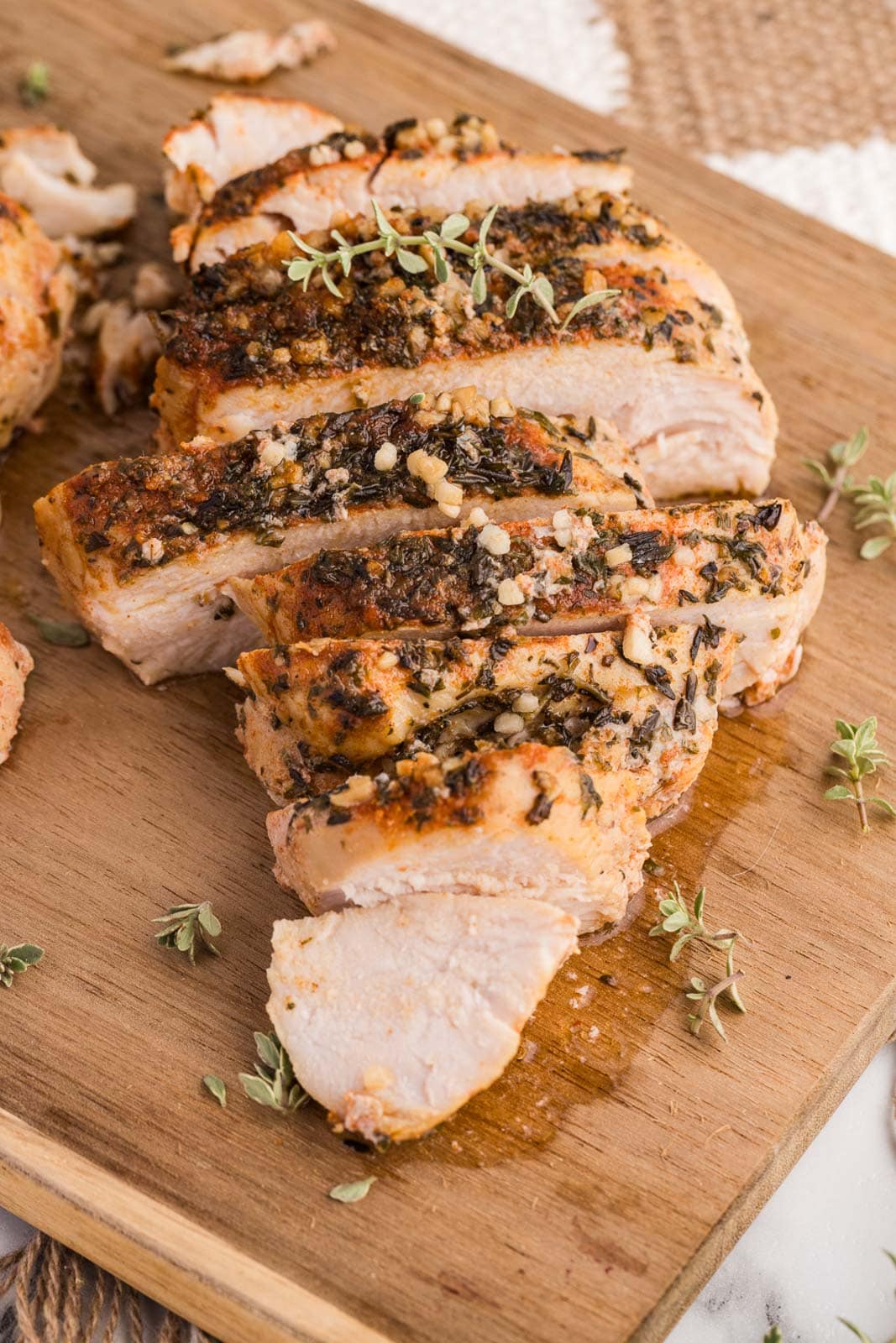 side view of sliced turkey breast on a wooden cutting board