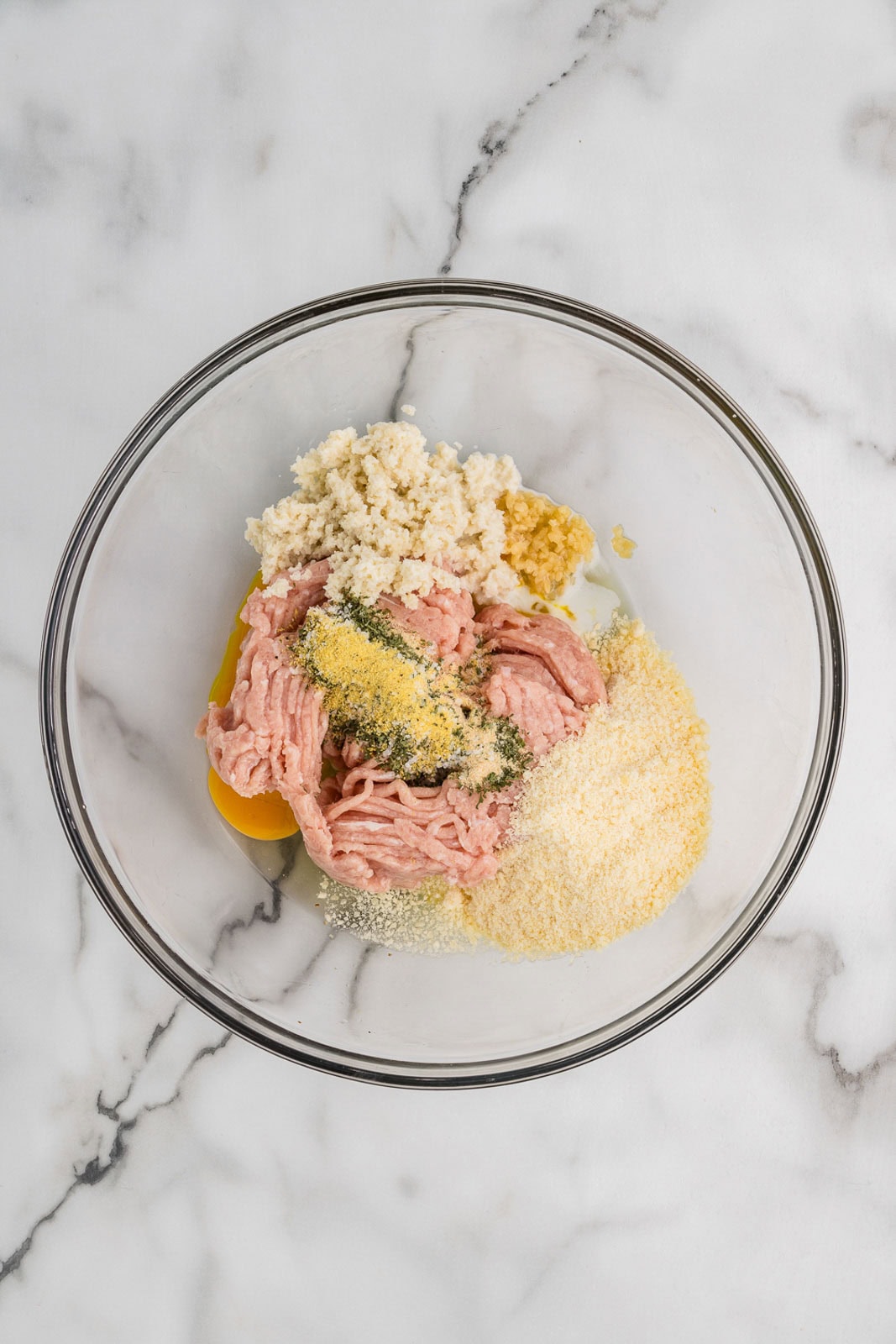 glass bowl of all meatball ingredients