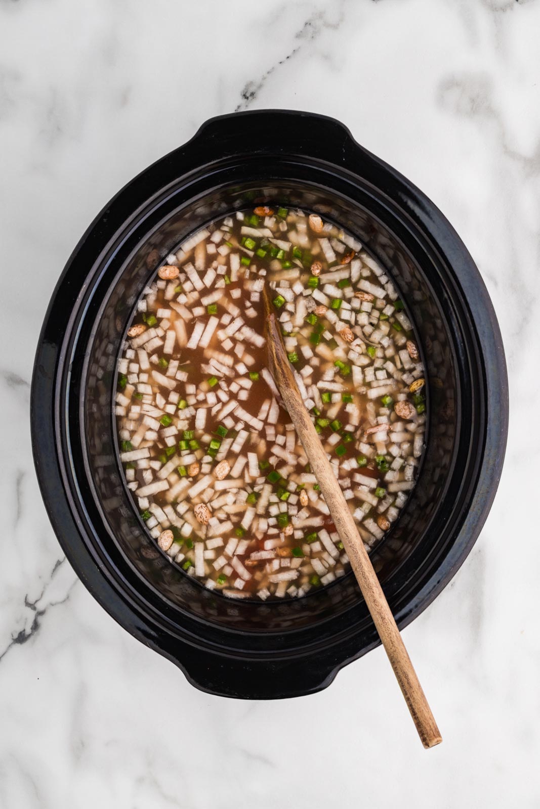 overhead view of black slow cooker of all ingredients