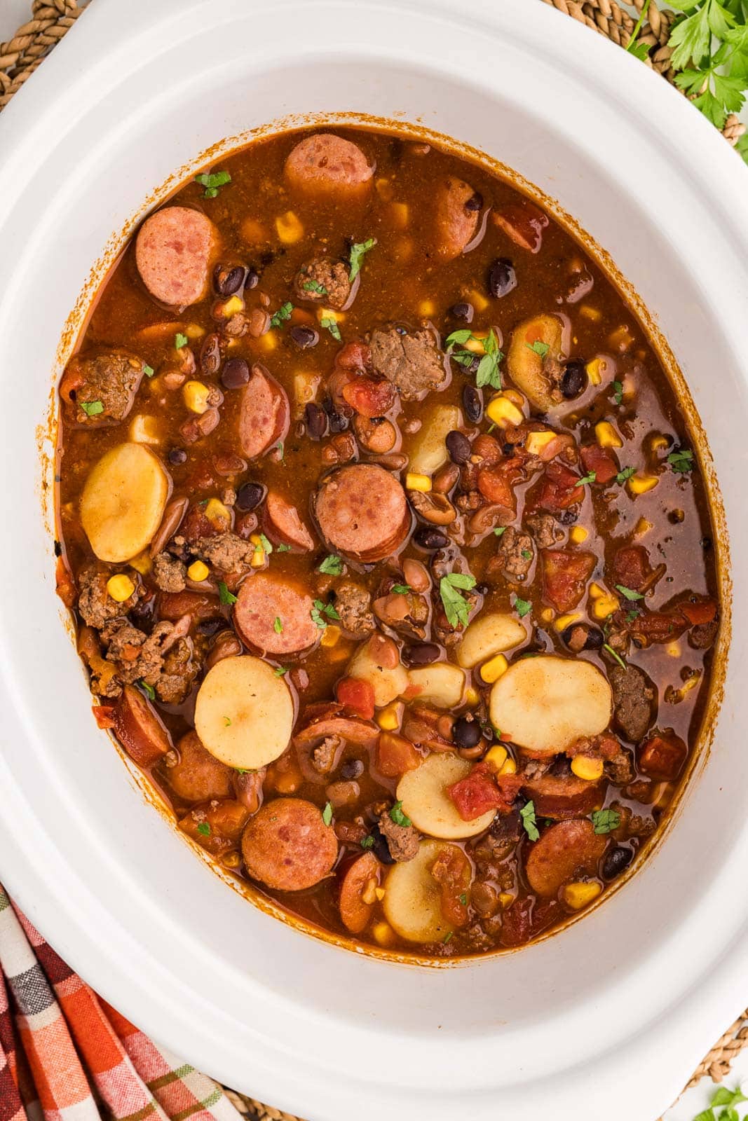 white slow cooker with completed cowboy stew