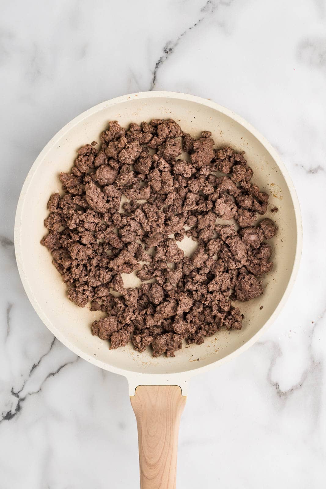 cream colored frying pan with cooked ground beef