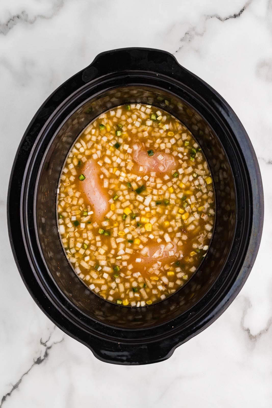 black slow cooker containing all ingredients