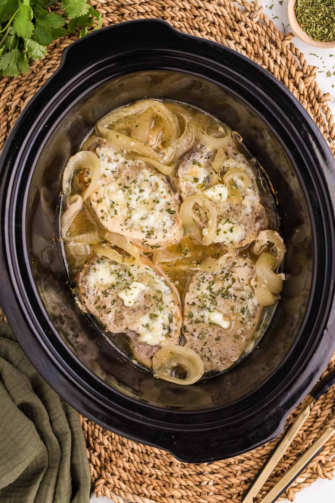 overhead view of some cooked onions and pork chops