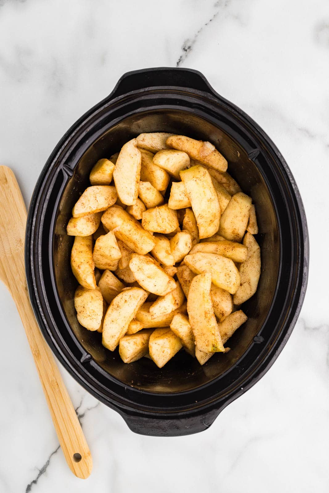 overhead view of black slow Cooker with cooked apples