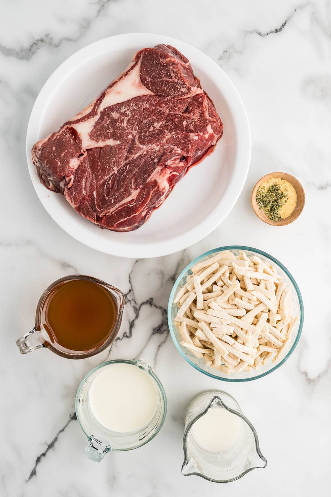 containers of ingredients to include chuck roast, her and garlic seasoning, beef broth, cornstarch and water, Reames noodles, and heavy cream