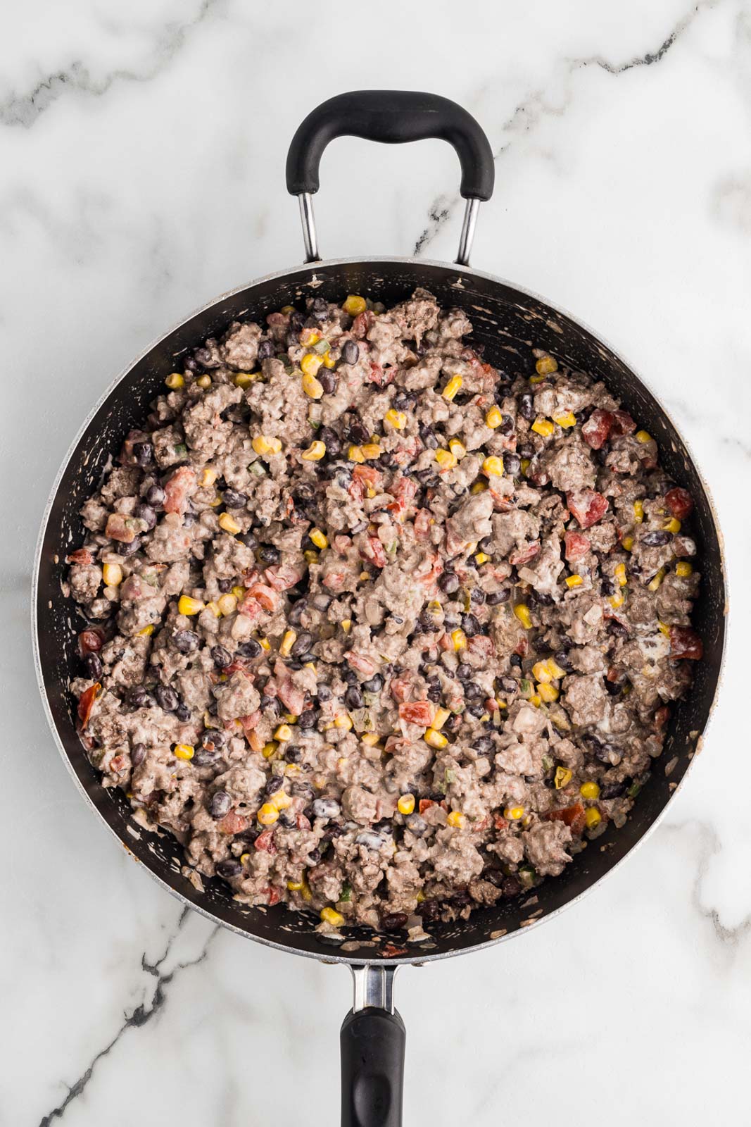 black skillet of combined ground beef mixture