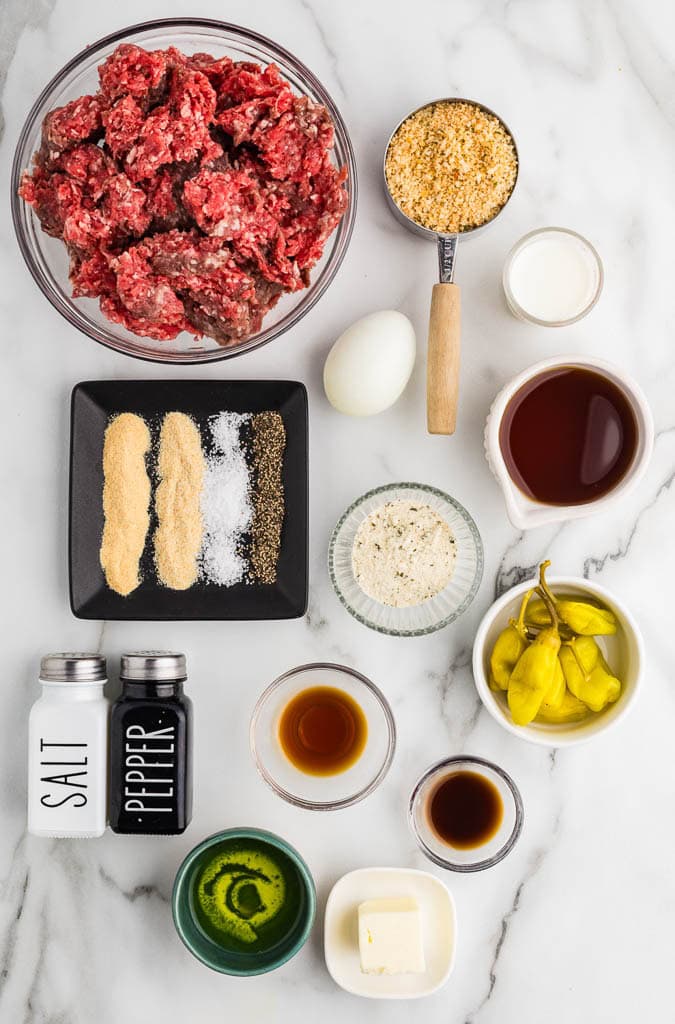 ingredients to include containers of ground beef, breadcrumbs, 1 egg, milk, container of garlic and onion powder, salt and black pepper, along with containers of beef broth, Worcestershire sauce, ranch seasoning, butter, pepperoncini peppers and juice, and salt and pepper shakers