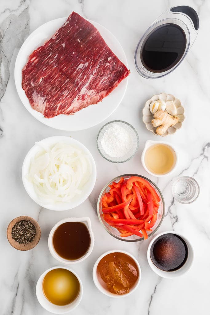 Ingredients to include containers of flank steak, onion, sliced red pepper, soy sauce, apricot preserves, rice vinegar, garlic cloves, ginger, sesame oil, beef broth, Worcestershire sauce, black pepper, corn starch and water