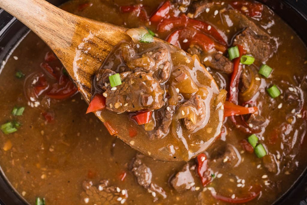 closeup view of beef teriyaki in black slow cooker