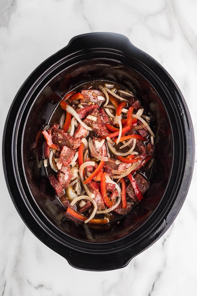 overhead view of beef, onions, red pepper and sauce